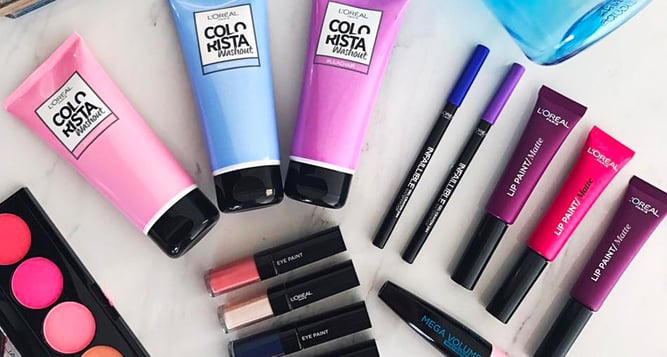 L'Oreal beauty products lying flat including eyeliner lipstick lipgloss and eyeshadows